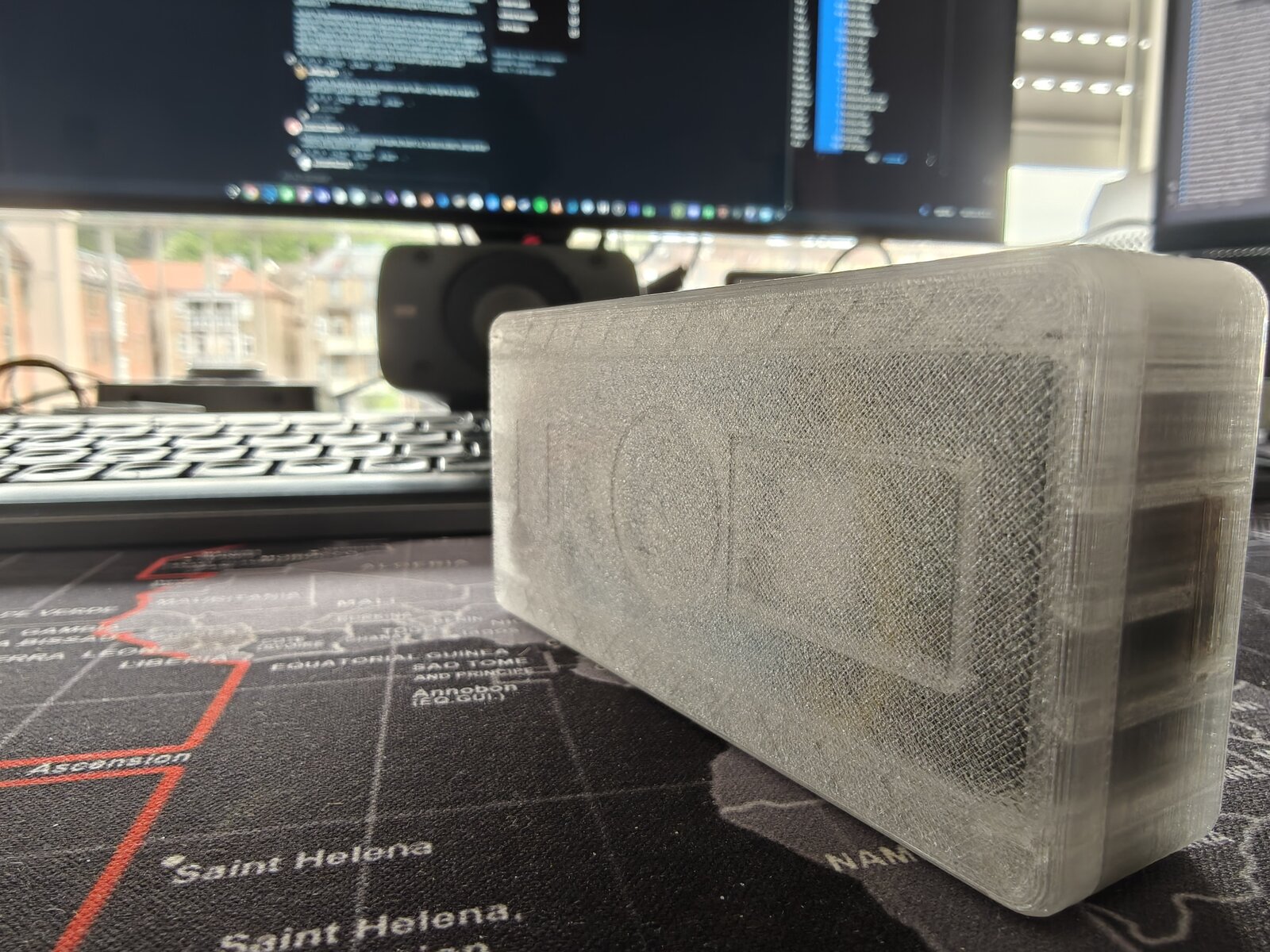 Mk2 translucent Dilder — back view showing TP4056, battery, and piezo ring visible through translucent walls