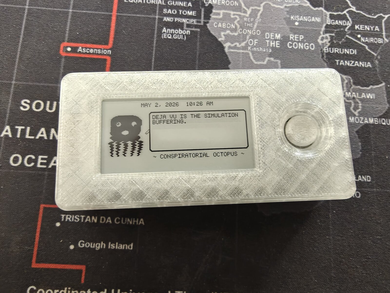 Mk2 translucent Dilder — isometric view showing Conspiratorial Octopus on e-ink display, internals visible through clear PETG case