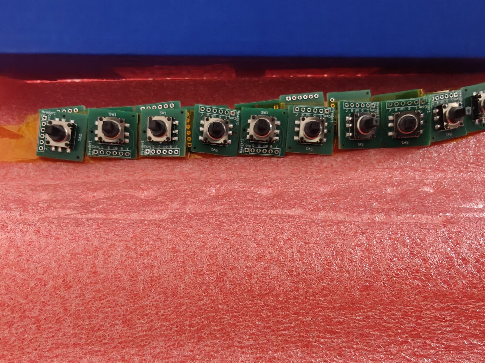 Closeup of joystick breakout board panel showing K1-1506SN-01 switches mounted and silkscreen labels