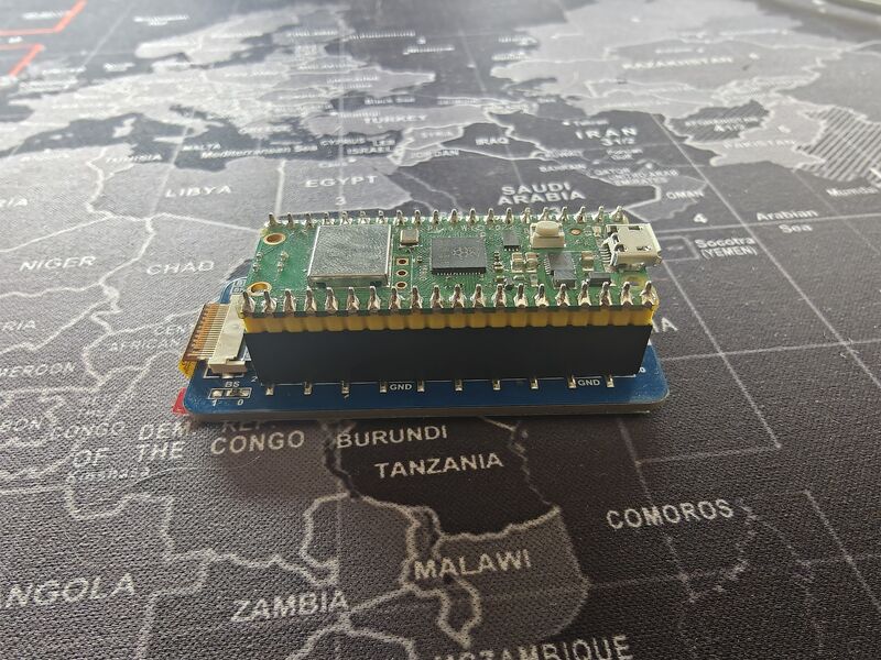 Pico W mounted on the Waveshare HAT — side view showing header connection